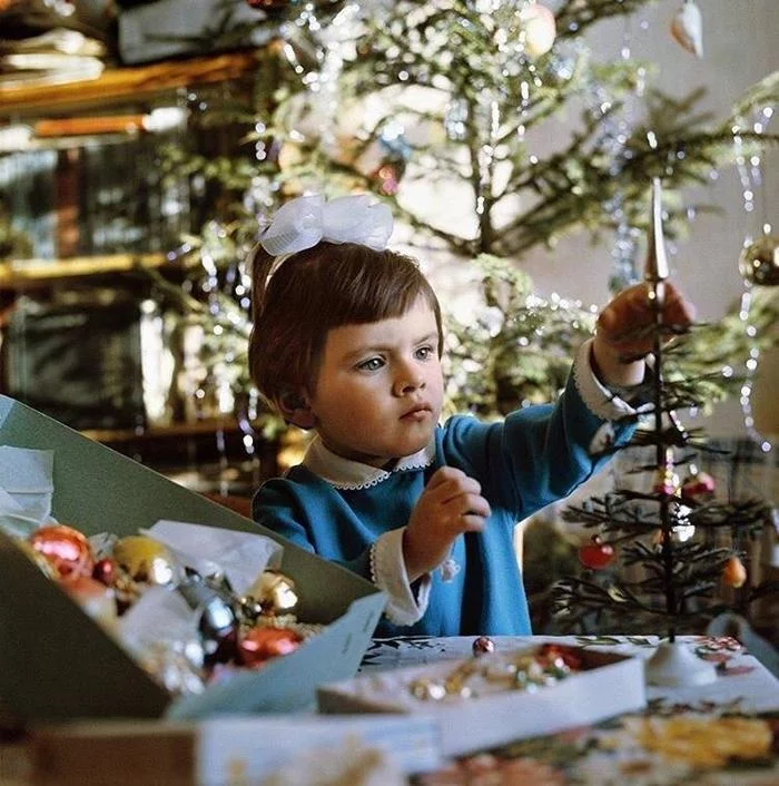 A girl decorates a tiny Christmas tree. USSR, 1973 - Story, New Year, the USSR, Christmas tree, Children