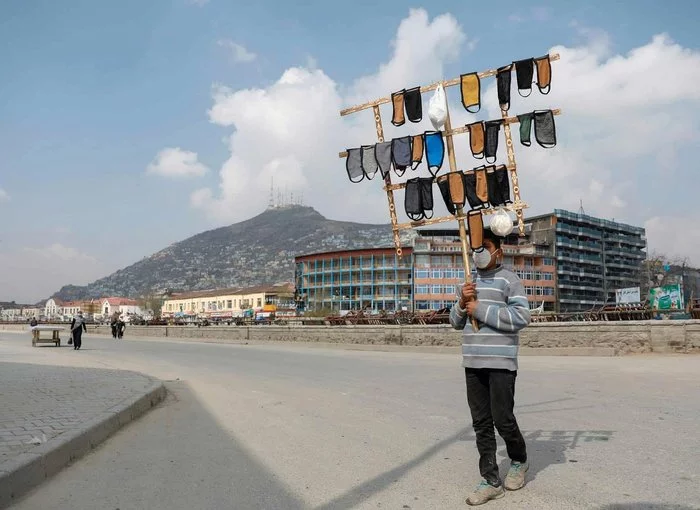 A boy selling protective face masks in Kabul - Afghanistan, Kabul, The photo, Coronavirus, Medical masks