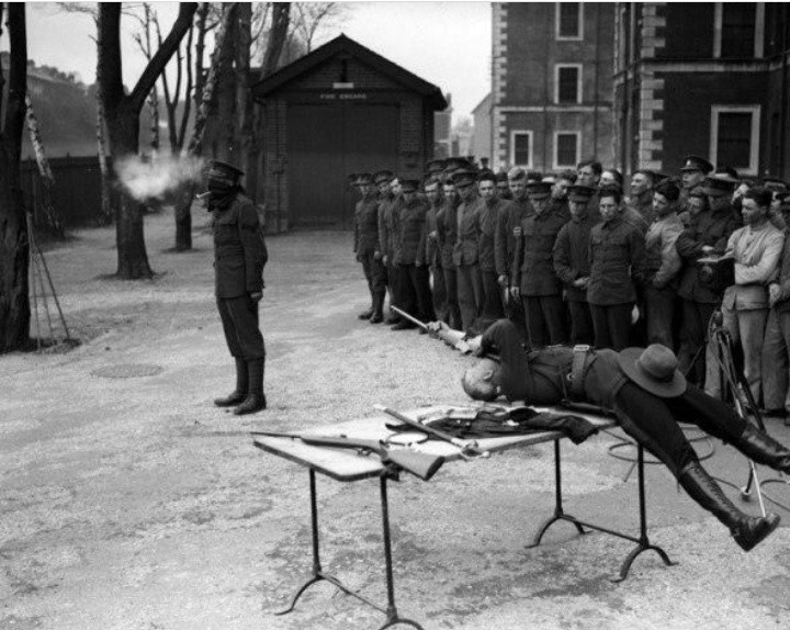 Captain George Ash, lying on his back, firing at a clay pipe held in his teeth, 1932 - Extreme, Weapon, Shooting, Captain