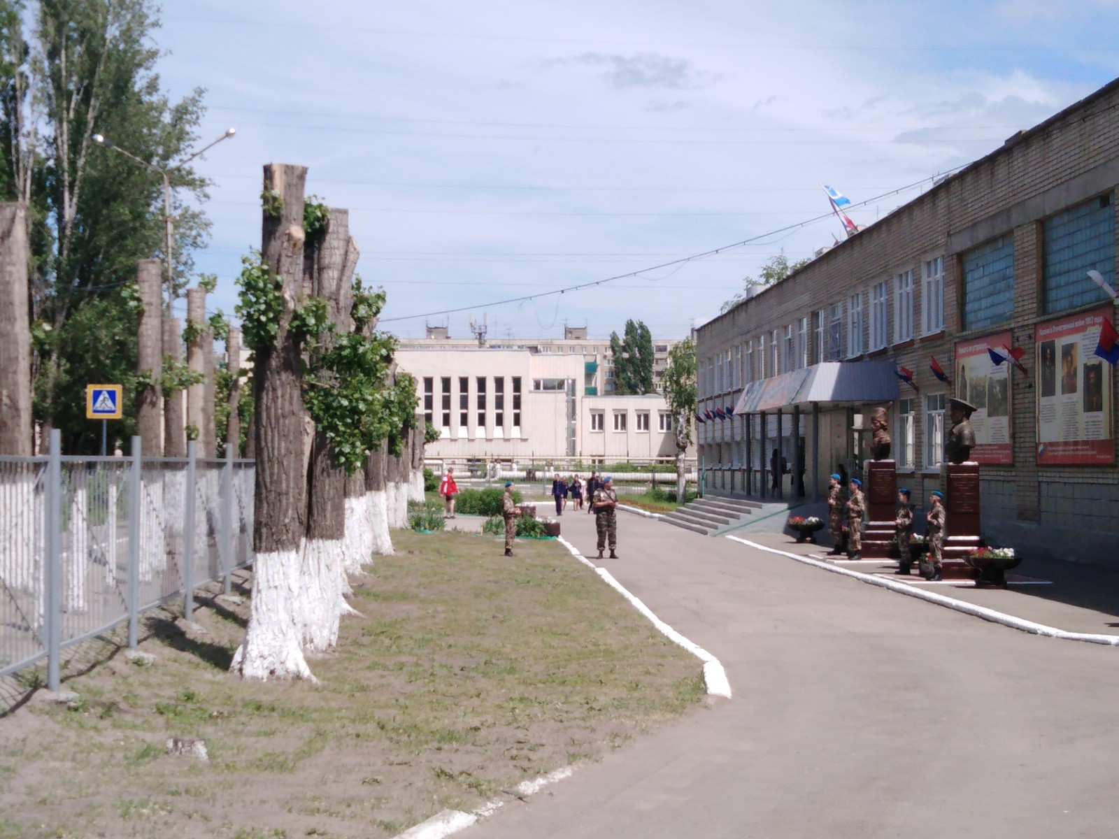 Children in military uniforms, blue berets and with guns were placed at the school in front of high whitewashed stumps ... - My, Children, Whitewash, Saratov, Longpost